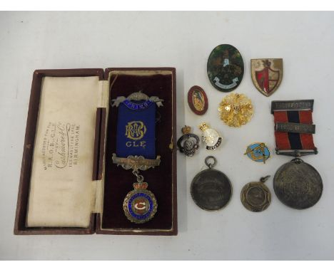 A small group of badges and medals, some enamel including a silver National Fire Brigade Association medal, Kingswood Fire Br