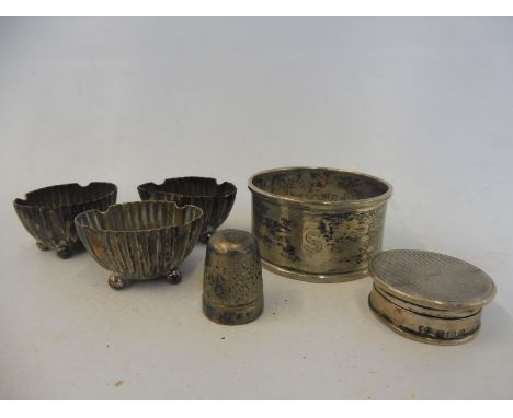 Three miniature silver salts, a silver pill pot, a silver napkin ring and a thimble.