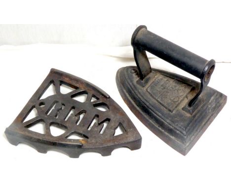 A heavy flat iron marked Silvesters Patent and a trivet marked R M M. 