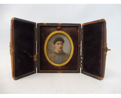 A leather cased oval portrait miniature of a lady. 