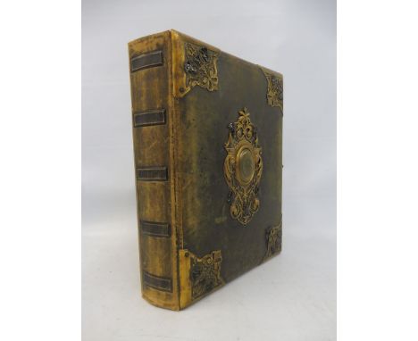 A good quality late Victorian leather photograph album with gilded brass and black enamel mounts, with assorted photographs i