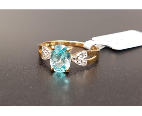 CERTIFIED BLUE AND WHITE ZIRCON RINGthe central Ratanakiri blue zircon weighing 1.97cts flanked by Ratanakiri white zircons t