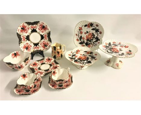 LATE VICTORIAN WILEMAN TEA SERVICEdecorated with red flowers with black panels and gilt highlights, comprising eight cups, el