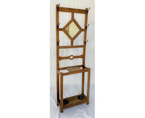 ARTS AND CRAFTS LIGHT OAK HALL STANDwith a central diamond shaped mirror flanked by six shaped hat hooks, with a pierced stre