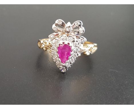 UNUSUAL RUBY AND DIAMOND CLUSTER RINGthe pear cut ruby in diamond surround and surmounted by a diamond set bow, on nine carat