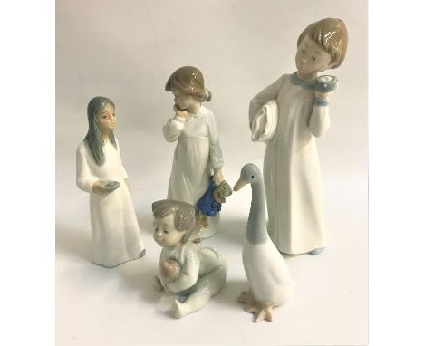 THREE NAO FIGURINEScomprising a boy with pillow and alarm clock, 25cm high, girl holding teddy bear, 20.5cm high, baby holdin