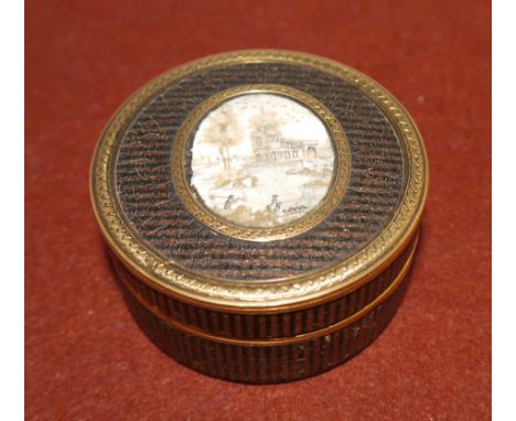 A late 18th century/early 19th century circular tortoise shell lined and gilt metal mounted trinket box with oval miniature l