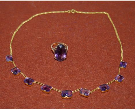 A yellow metal necklace set with 9 rectangular Brazilian amethyst (unmarked) matching ring set with a large oval amethyst sta