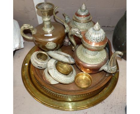 An ornate Indian silvered metal and copper teapot, jug and metalware