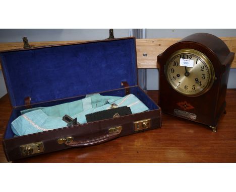 An Edwardian striking mantle clock; a set of Masonic regalia in case; a gilt framed wall mirror