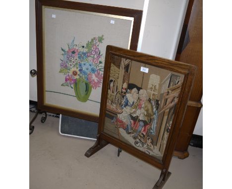 An oak fire screen with Berlin tapestry panel and another 