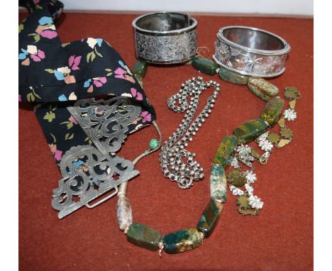 A Victorian white metal bangle with chased and 2 colour gold scene of birds; a moss agate necklace; a nurse’s buckle etc.