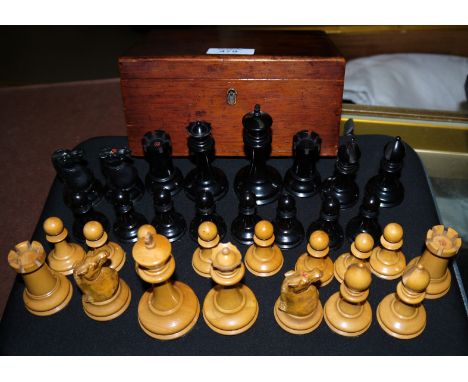 A Victorian turned ebonized and boxwood chess set with weighted bases in presentation box; height of king 3.5''