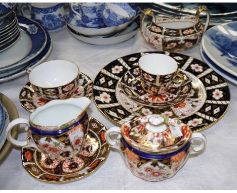 A selection of Royal Crown Derby including a milk jug/sugar; another sugar bowl; 2 cups and saucers; an individual plate