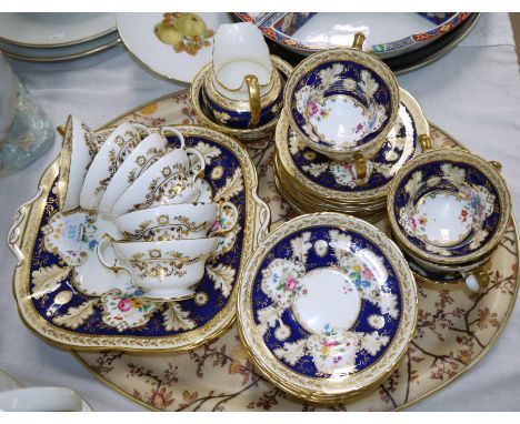 Cauldron for Harrods, a 12 setting (approx 40 pieces) tea service with polychrome floral decoration with blue and gilt border