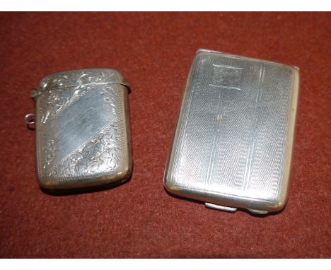 A silver matchbook case with engine turned decoration; a Vesta case