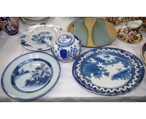 A 19th century tin glaze Delft plate, and another similar (both cracked/chipped); a blue & white teapot; a Skipton Studio pla