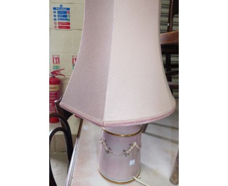 An Edwardian oak framed wall mirror; a pink china table lamp