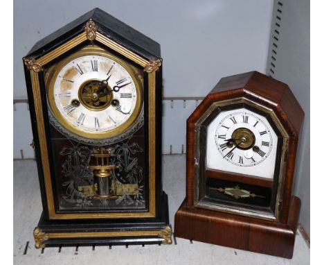 A 19th century American ebonised and gilt mantel clock with musical instrument decoration, and striking movement; a similar m