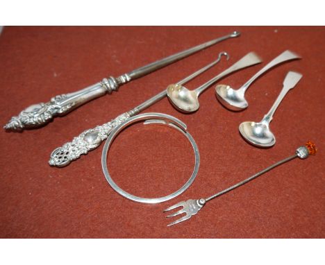 A pair of Georgian silver salt spoons; a silver bangle; 3 other items