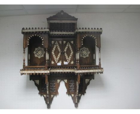 A MOORISH STYLE WALL CABINET of inverted breakfront outline with central cupboard flanked on each side by open shelves betwee