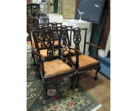A SET OF SIX CHIPPENDALE STYLE MAHOGANY DINING CHAIRS including a pair of elbow chairs each with a pierced verticle splat wit