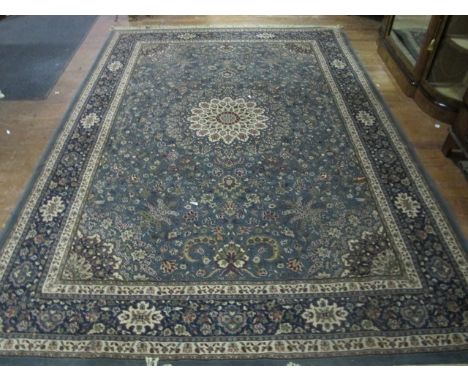 A WOOL RUG the light blue ground with beige border and overall floral pattern 280cm x 200cm