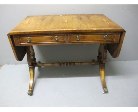 A FINE YEW WOOD CROSS BANDED SOFA TABLE the rectangular hinged top with two frieze drawers and opposing mock drawers on stand