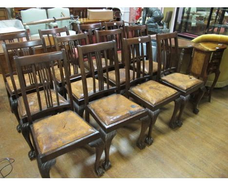 A SET OF TWELVE CHIPPENDALE STYLE MAHOGANY DINING CHAIRS each with a pierced vertical splat above a hide upholstered drop in 