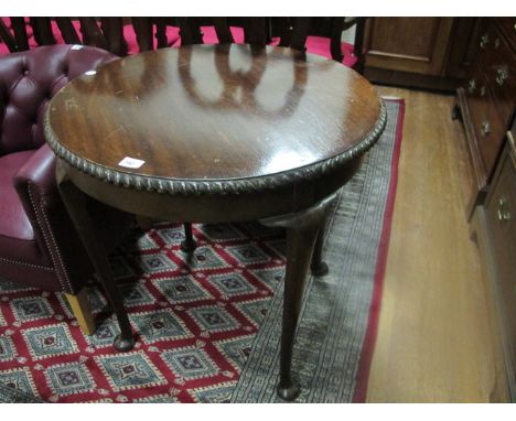 A CHIPPENDALE STYLE MAHOGANY OCCASIONAL TABLE the circular moulded top with gadrooned edge raised on cabriole legs with pad f