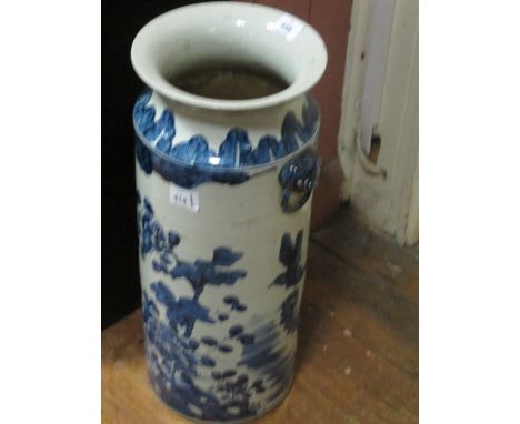 AN ORIENTAL STICK STAND the white and blue ground decorated with flowerheads and foliage with figural handles 56cm (h) x 23cm