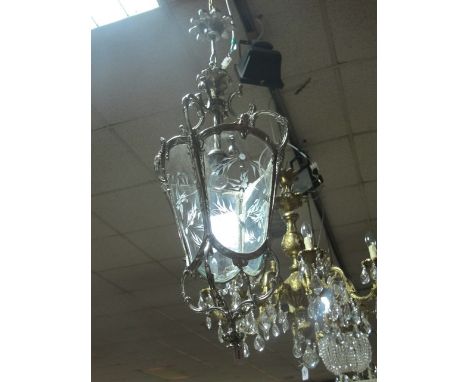 A CONTINENTAL SILVERED AND ENGRAVED GLASS SINGLE LIGHT HALL LANTERN with scroll arms and bowed panels with scroll terminals