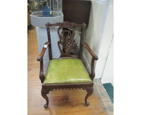 A CHIPPENDALE STYLE MAHOGANY CARVER the carved top rail above a pierced verticle splat with hide upholstered drop in seat and