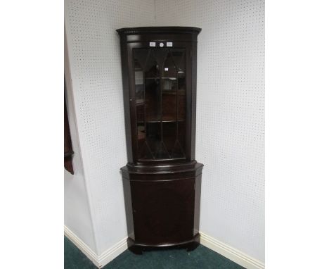 A PAIR OF MAHOGANY BOW FRONT CORNER CABINETS with astragal glazed doors the base with cupboard on bracket feet 118cm (h) x 53