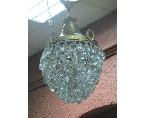 A GILT BRASS AND CUT GLASS CENTRE LIGHT the leaf cast circlet hung with laurel wreaths above a tapering frame hung with penda