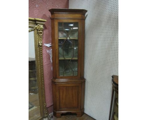 A SATINWOOD CORNER CABINET the outset moulded cornice above astragal glazed door the base with panel door between canted angl