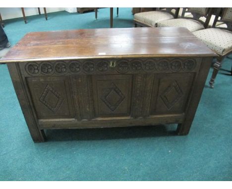 AN OAK TRUNK 19th Century the rectangular hinged lid above a carved frieze on square block legs 72cm (h) x 127cm (w) x 52cm (