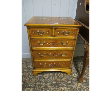 A YEW WOOD WALNUT AND POLYCHROME CHEST of rectangular form the shaped moulded top decorated with flower filled cornucopias ab