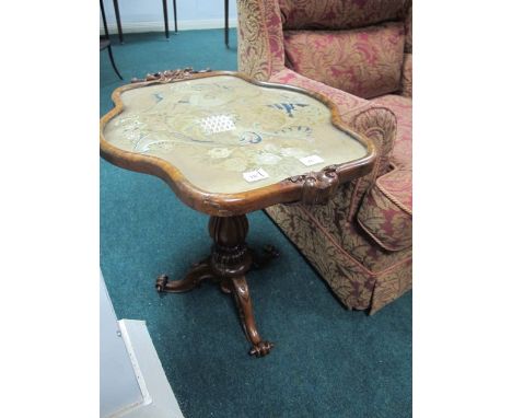 A VICTORIAN ROSEWOOD OCCASIONAL TABLE the shaped top with needlework panel raised on baluster support and tripod base with sc