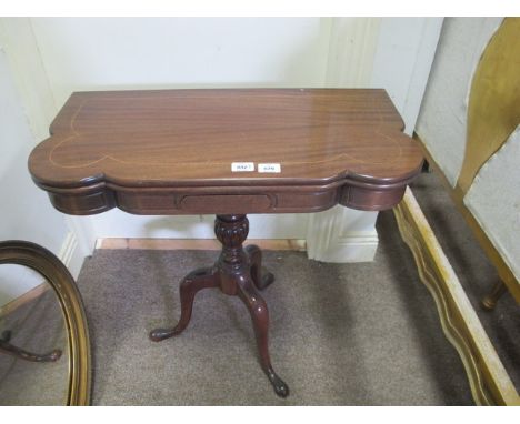 A MAHOGANY FOLD OVER CARD TABLE the rectangular shaped moulded hinged top containing baize lined interior raised on a baluste