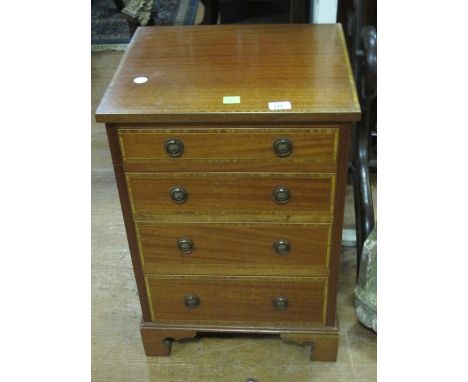 A MAHOGANY AND SATINWOOD CROSS BANDED CHEST the rectangular top above four long graduated drawers with brass ring handles on 