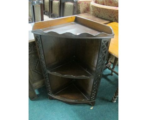 A MAHOGANY CORNER SHELF 19th Century with moulded gallery above two open shelves between pierced uprights on bracket feet 84c