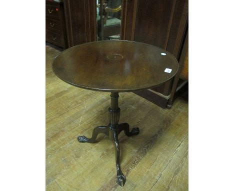 A GEORGIAN STYLE MAHOGANY TABLE the circular dish top above a baluster column on tripod support with claw and ball feet 