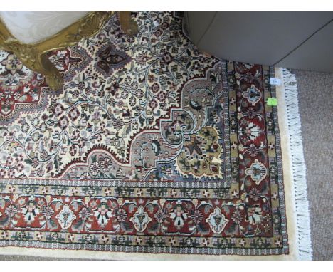 A WOOL RUG the light blue and beige ground with overall floral pattern 188cm x 126cm