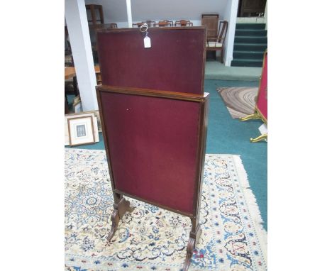 A GEORGIAN MAHOGANY FIRESCREEN of rectangular form with upholstered panels and adjustable screen on standard end supports wit