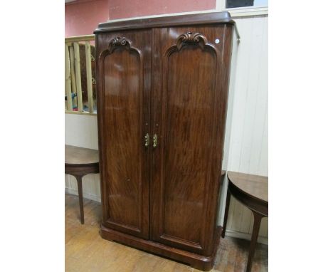 A GOOD VICTORIAN MAHOGANY TWO DOOR WARDROBE the moulded cornice above a pair of rectangular arched panelled doors with scroll