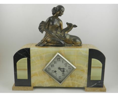 In the Art Deco style, a mantel clock and garniture. H.39cm W.43cm