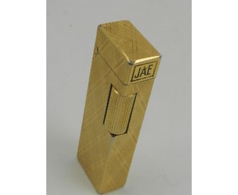 A gilt metal plated Colibri gas filled cigarette lighter, monogrammed 'J. A. E'.