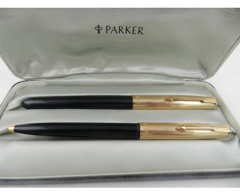 A cased Parker 51 fountain and ball point pen, having engine turned gold plated caps.