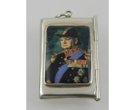 A white metal stamp box, in the form of an envelope, set with a faux enamel plaque depicting Winston Churchill in military un
